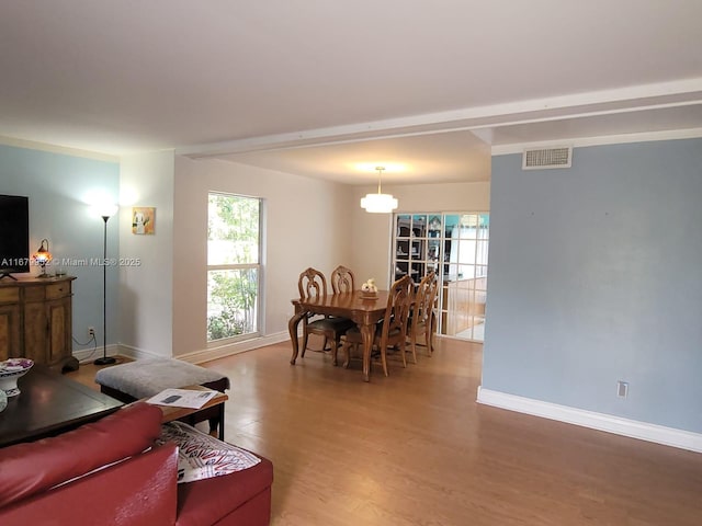 living room with hardwood / wood-style floors and crown molding