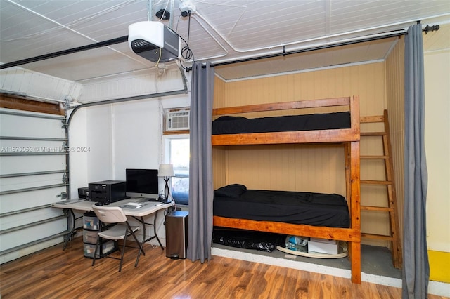 garage featuring a garage door opener and wood walls