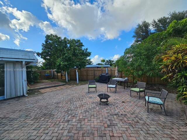 view of patio / terrace with an outdoor fire pit