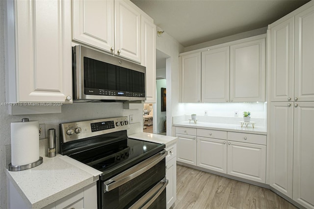 kitchen featuring light hardwood / wood-style floors, white cabinets, and stainless steel appliances