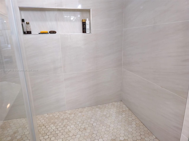 bathroom with a tile shower