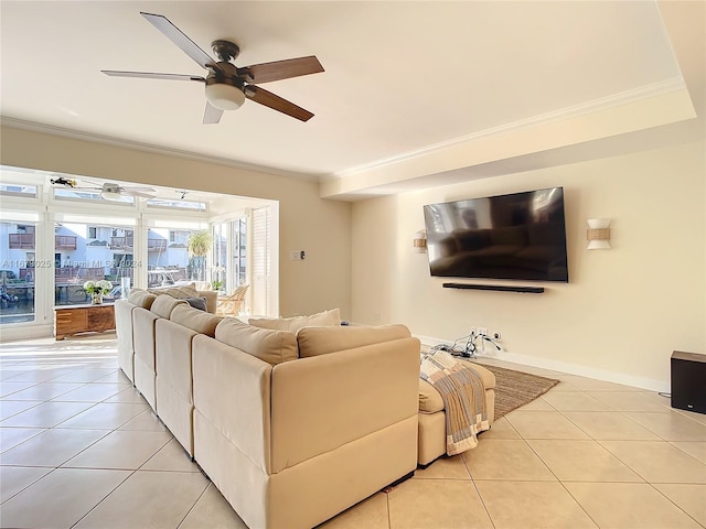 tiled living room with ceiling fan and crown molding