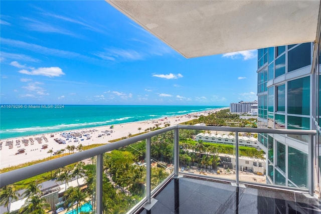 balcony featuring a water view and a view of the beach