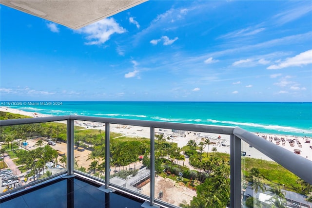 balcony with a water view and a beach view