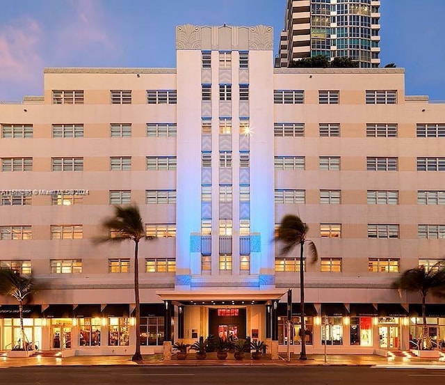 view of outdoor building at dusk