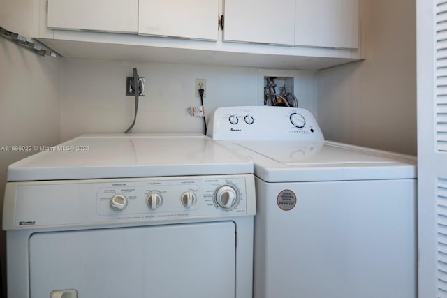 clothes washing area featuring cabinets and independent washer and dryer