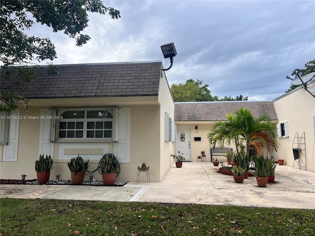 11369 SW 169th St Unit 5442D, Miami, FL 33157 - back of house with roof with shingles, stucco siding, a patio, and mansard roof