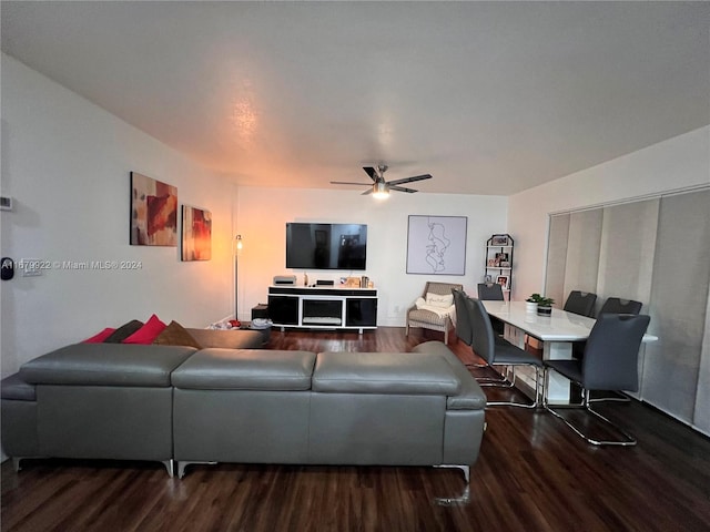 living room featuring dark hardwood / wood-style floors and ceiling fan