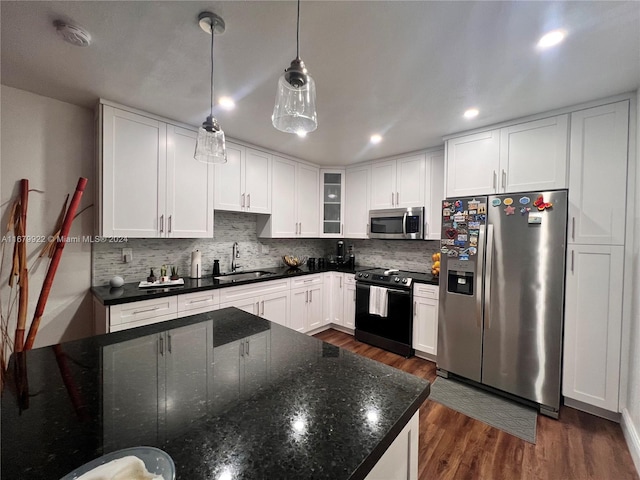 kitchen featuring hanging light fixtures, white cabinetry, dark wood-type flooring, sink, and stainless steel appliances