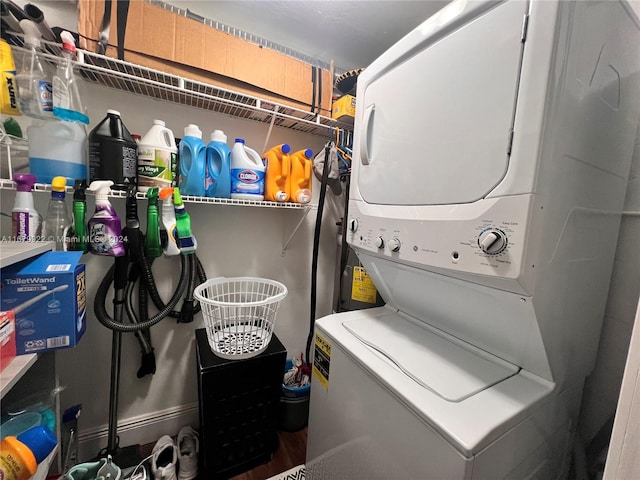 clothes washing area with stacked washer and dryer