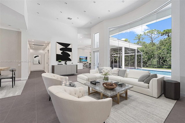 tiled living room with a towering ceiling