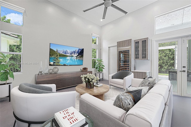 living room with a high ceiling and ceiling fan