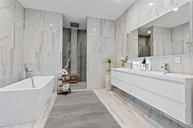 bathroom featuring vanity, tile walls, and separate shower and tub