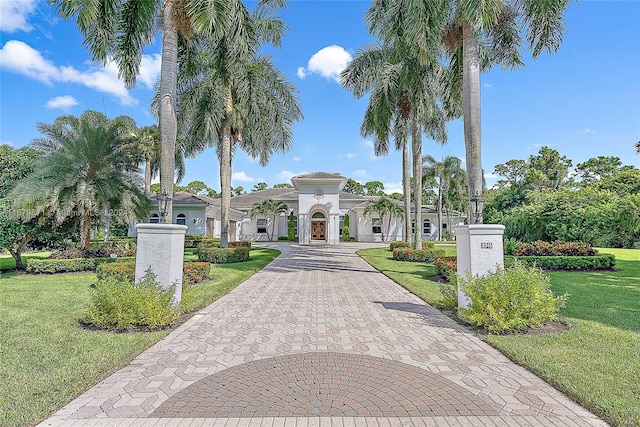 mediterranean / spanish house featuring a front lawn