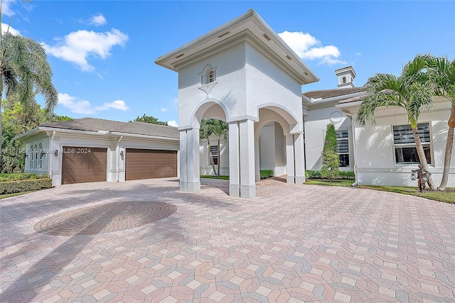 mediterranean / spanish home featuring a garage