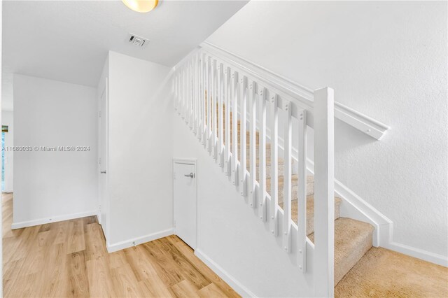 staircase featuring hardwood / wood-style flooring