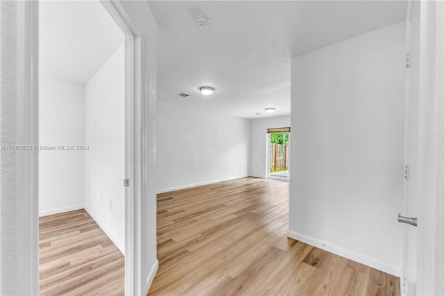 corridor with light hardwood / wood-style flooring