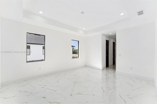 empty room with a tray ceiling