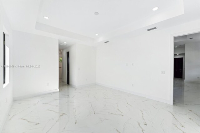 empty room featuring a tray ceiling