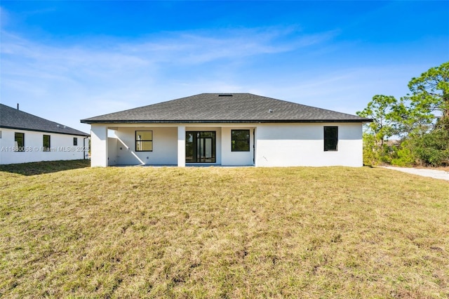 rear view of property with a yard