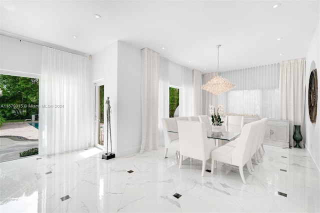 dining area with an inviting chandelier