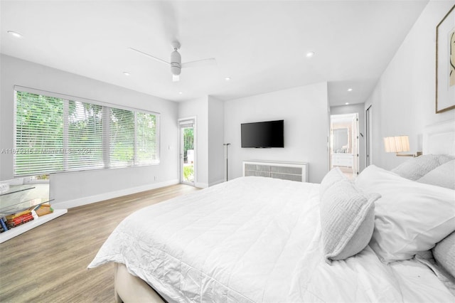 bedroom featuring ceiling fan, light wood-type flooring, and ensuite bath