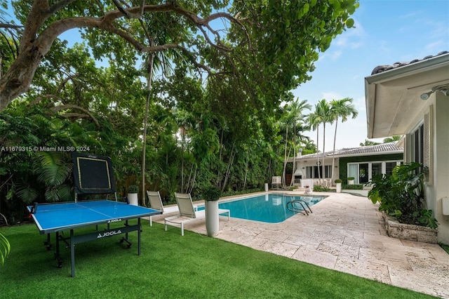 view of pool featuring a yard and a patio area