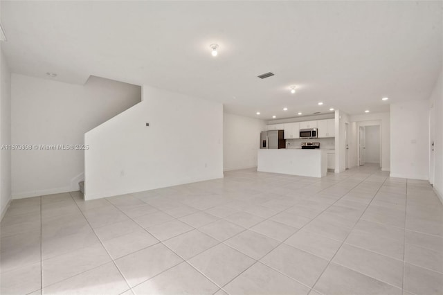 unfurnished living room featuring light tile patterned floors