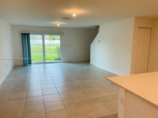 unfurnished room with light tile patterned floors