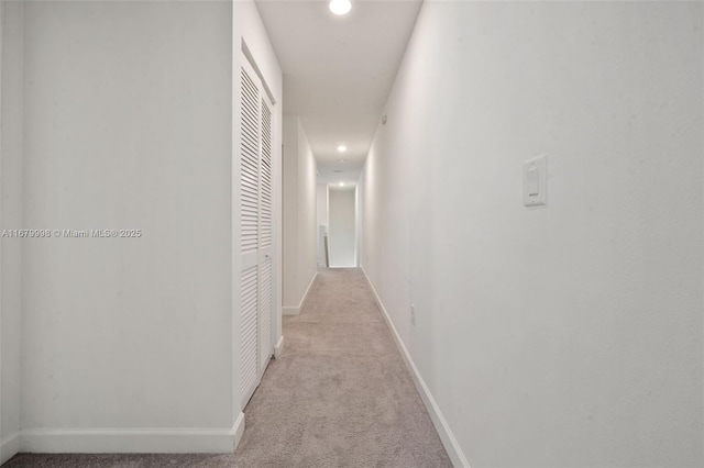 hall featuring light colored carpet