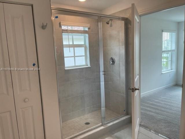 bathroom with a healthy amount of sunlight and walk in shower