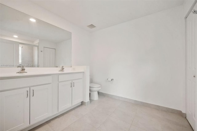 bathroom with vanity, tile patterned floors, and toilet