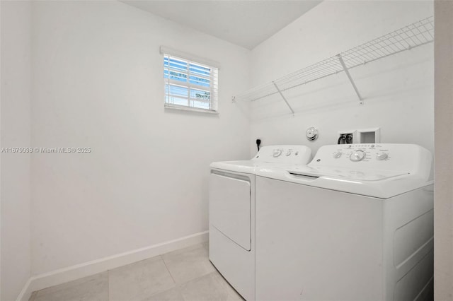 laundry area featuring light tile patterned flooring and separate washer and dryer