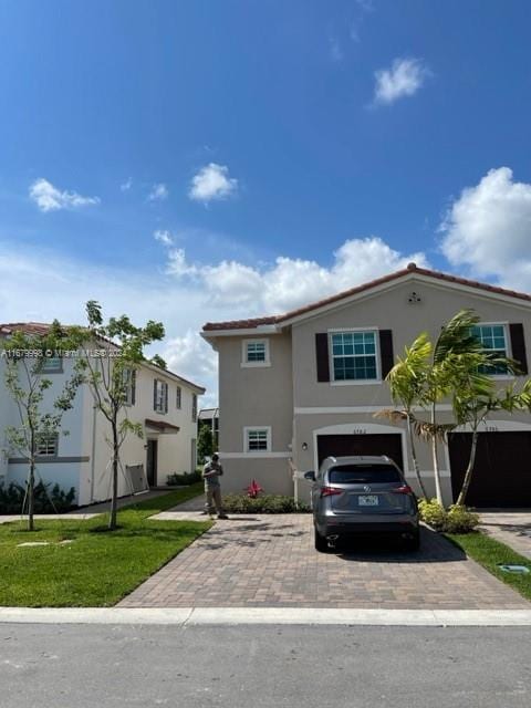 view of front of property with a front yard and a garage