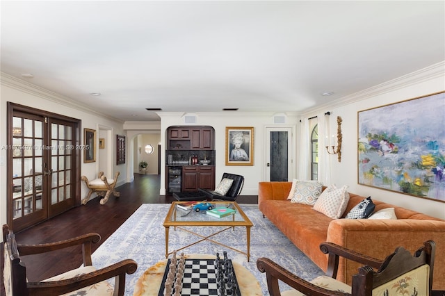 living area with wine cooler, ornamental molding, dark wood-style floors, french doors, and arched walkways