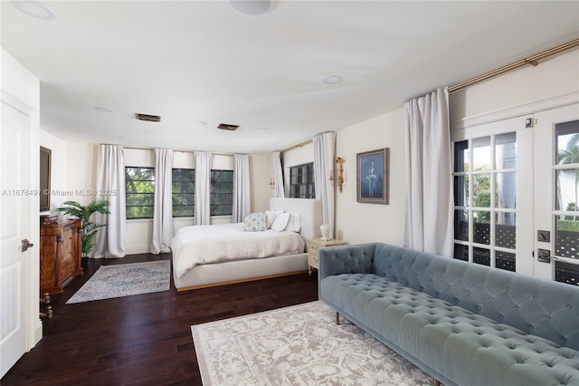 bedroom featuring visible vents and wood finished floors