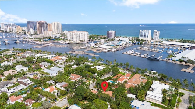 birds eye view of property with a water view and a city view