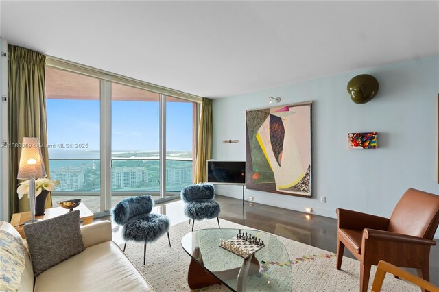 300 S Pointe Dr Unit 3204, Miami Beach, FL 33139 - living area featuring floor to ceiling windows, wood finished floors, and baseboards