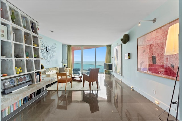 living area with a wall of windows and a water view