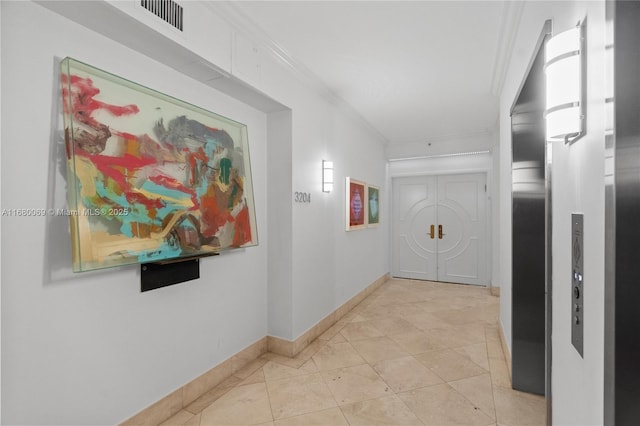 hallway with ornamental molding and light tile patterned flooring