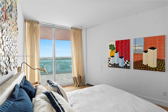 300 S Pointe Dr Unit 3204, Miami Beach, FL 33139 - carpeted bedroom featuring access to exterior and a wall of windows