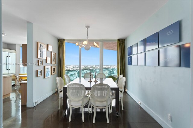 300 S Pointe Dr Unit 3204, Miami Beach, FL 33139 - dining space with a chandelier, dark tile patterned floors, expansive windows, and baseboards