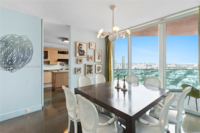 300 S Pointe Dr Unit 3204, Miami Beach, FL 33139 - dining space featuring a chandelier, floor to ceiling windows, a view of city, and baseboards