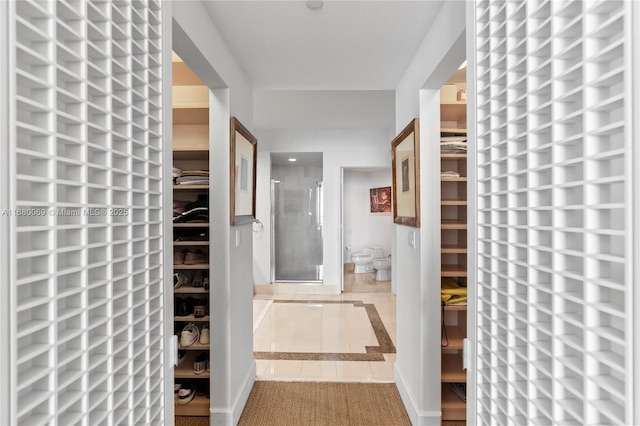 hallway with tile patterned flooring