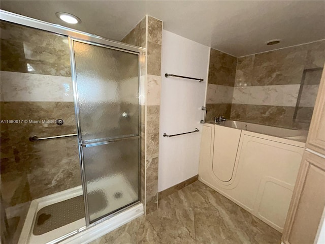 bathroom with separate shower and tub