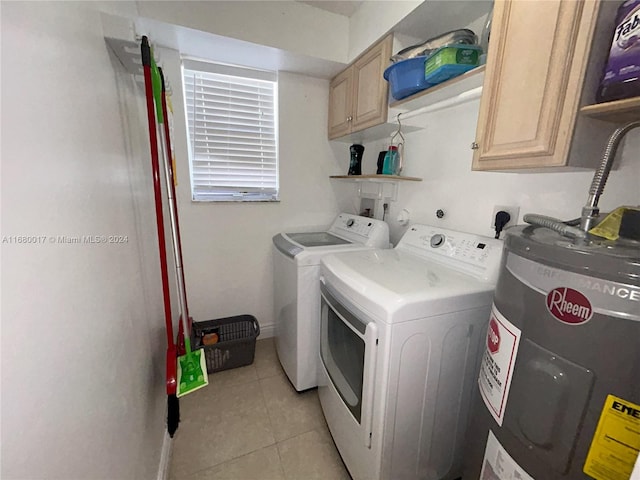 laundry area with cabinets, water heater, light tile patterned floors, and washer and dryer