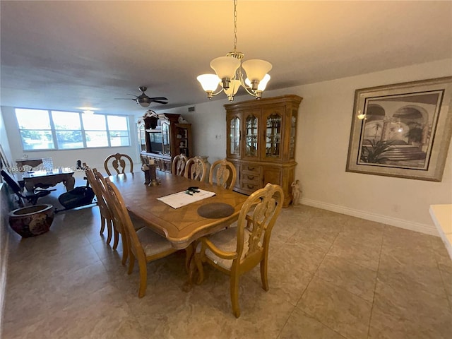 tiled dining room with ceiling fan with notable chandelier