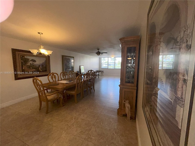 dining room featuring tile patterned floors and ceiling fan with notable chandelier