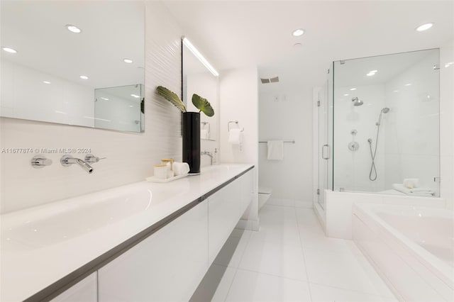 full bathroom featuring toilet, tile patterned floors, vanity, and separate shower and tub