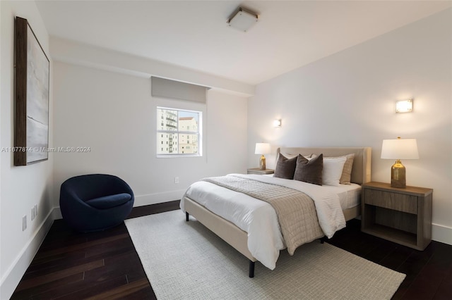 bedroom with dark hardwood / wood-style flooring